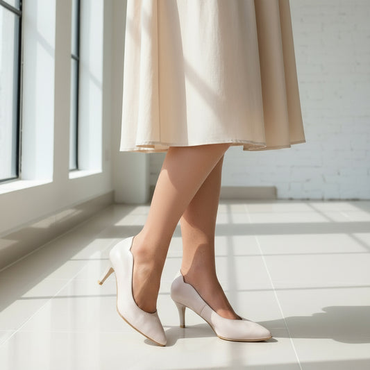 LUNA nude matte leather kitten heel court shoes with 6cm heel and ankle cut-out design worn on marble floor
