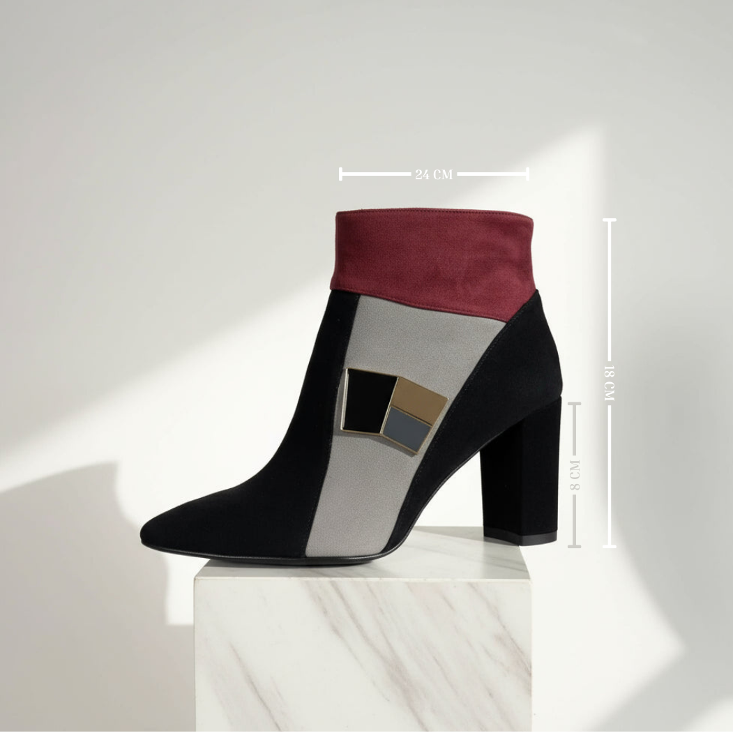 Black and red ankle boot on a white pedestal with measurement details.