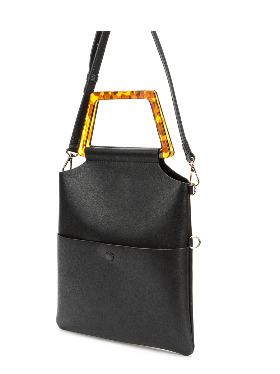 Black leather bag with a shoulder strap and a contrasting brown handle.