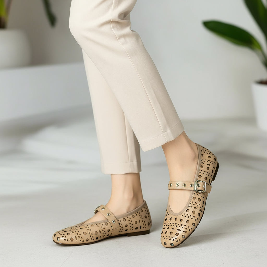 Person wearing beige leopard print shoes with a plain background