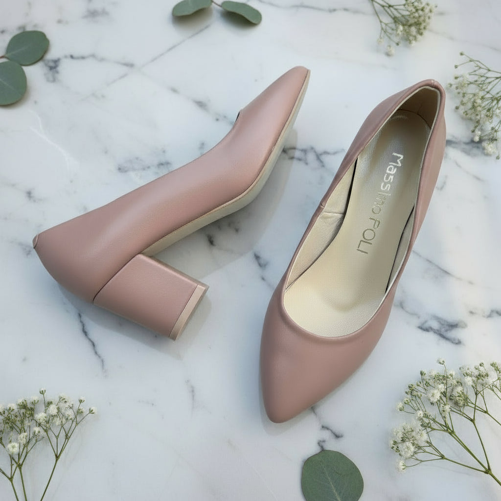 Pair of mauve high-heeled shoes on a light gray surface