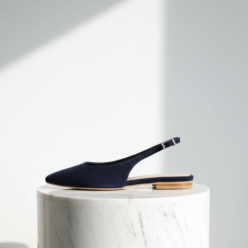 Profile view of ALICE navy suede slingback with pointed toe, silver buckle closure and 2cm low heel