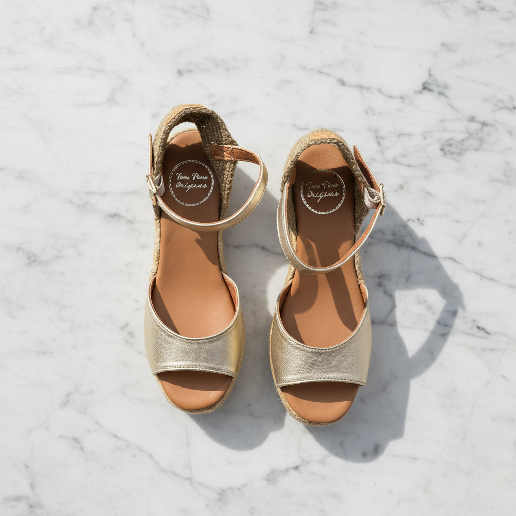  ALISIA gold leather espadrilles with jute wedge heel displayed on grass with daisy, perfect for petite feet.