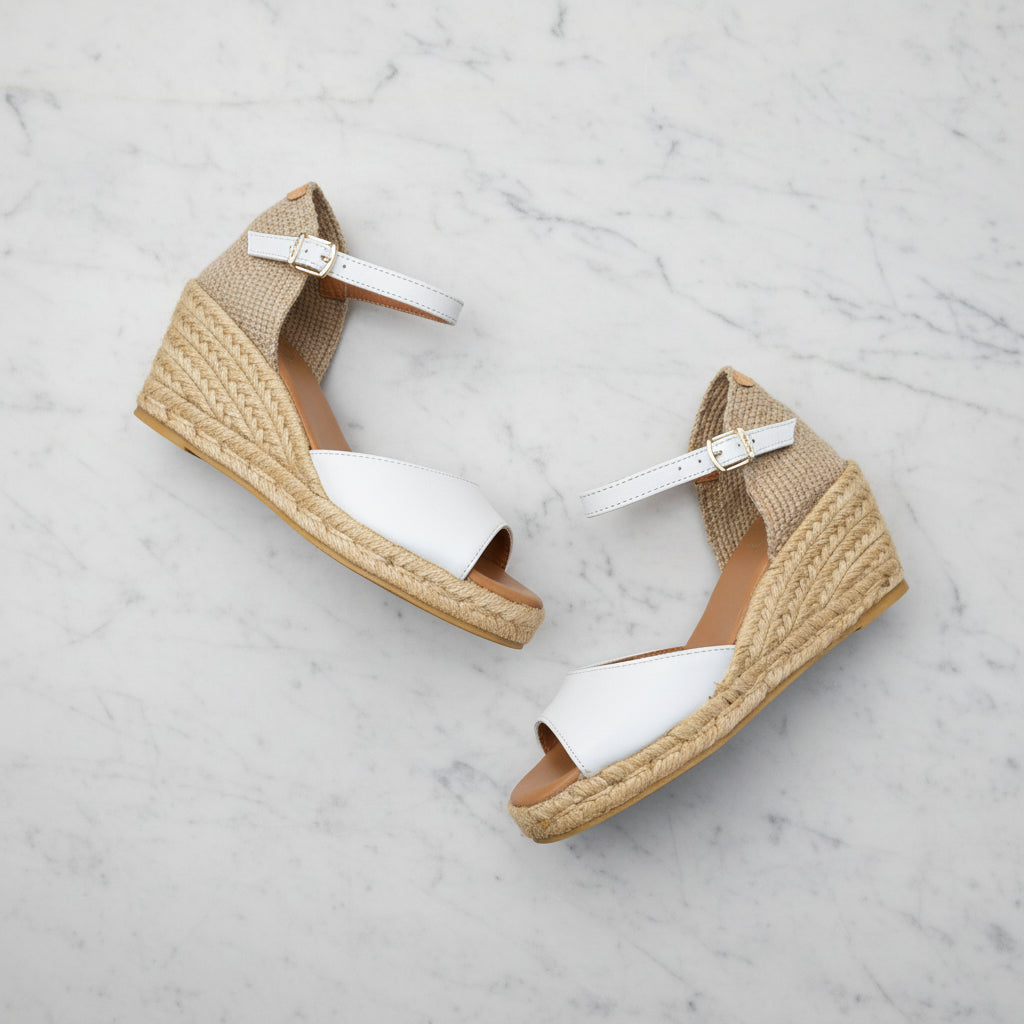 ALISIA white leather espadrilles with jute wedge heel on grass with daisy, featuring ankle strap for petite sizes.