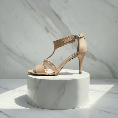Pair of green high-heeled sandals on a marble surface