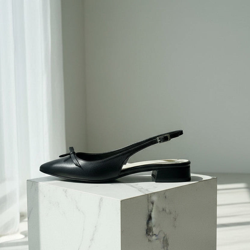 Black slingback shoes on a marble surface