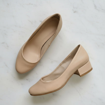 Nude leather petite formal pumps.