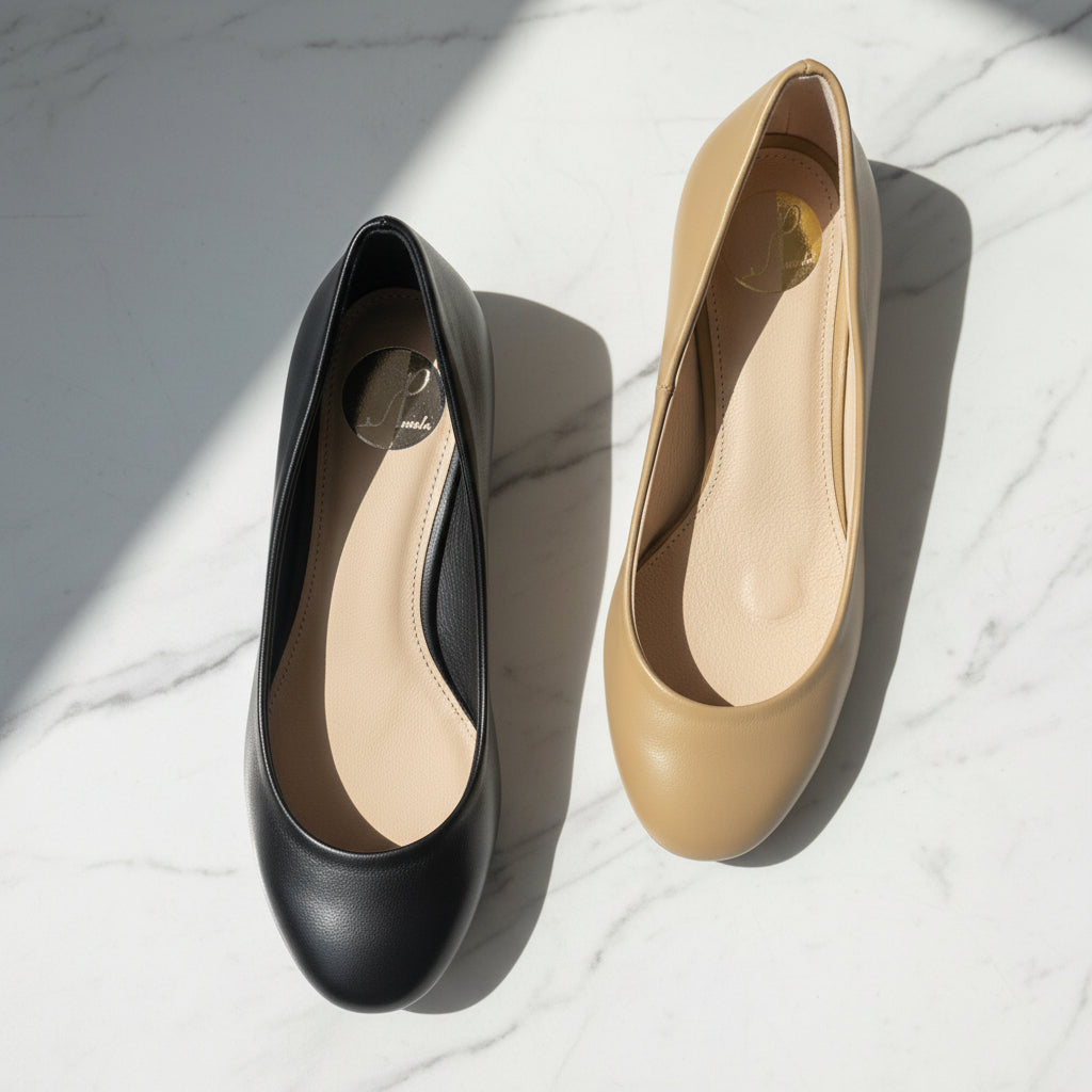 Black and beige high heels on a marble surface