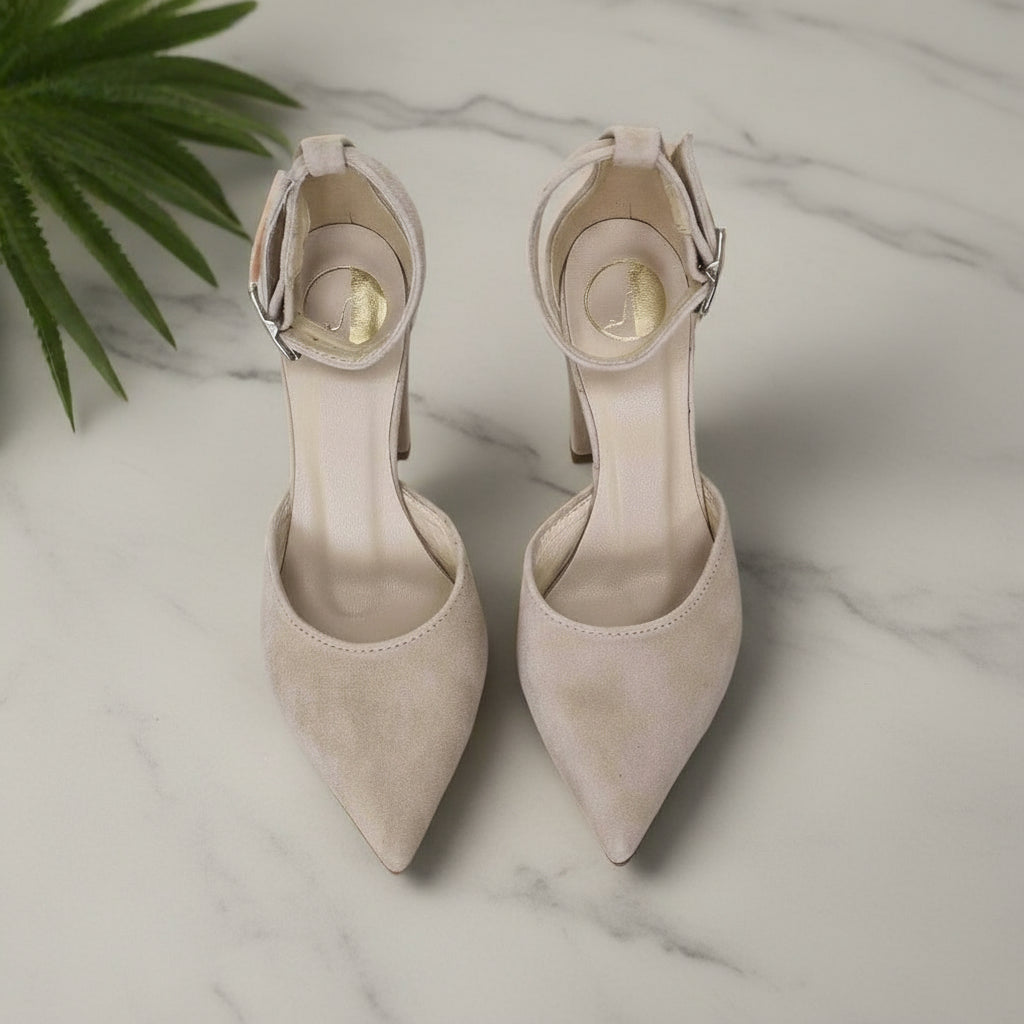 Top view of pair beige suede ankle strap heels with pointed toes and buckle, petite fit.