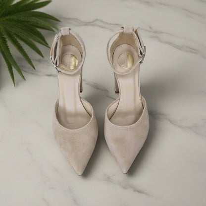 Top view of pair beige suede ankle strap heels with pointed toes and buckle, petite fit.