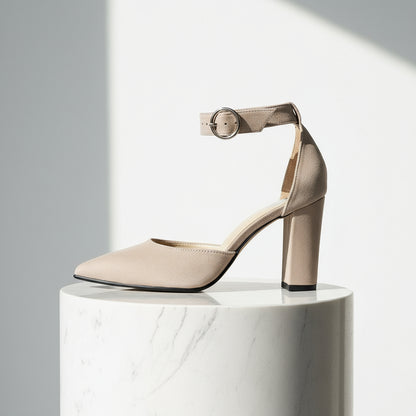 Beige high-heeled shoe with ankle strap on a white background