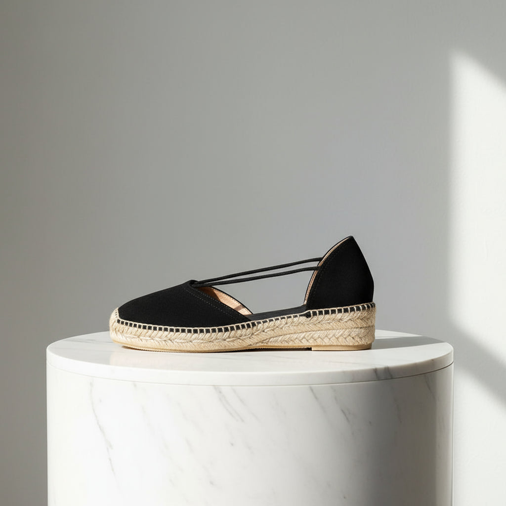 Side view of black suede espadrille with elastic straps and natural jute sole, crafted for small women's feet.