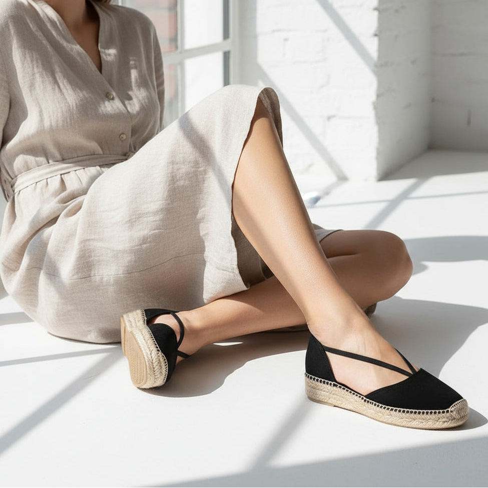Black suede espadrilles with elastic straps shown on model, designed specifically for women with small feet.