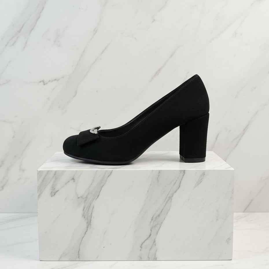 Side view of black suede block heel shoes showing rounded toe and sturdy block heel