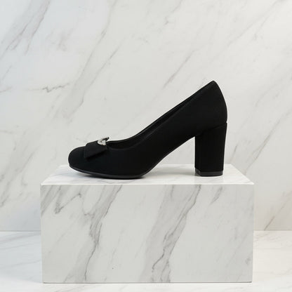 Side view of black suede block heel shoes showing rounded toe and sturdy block heel