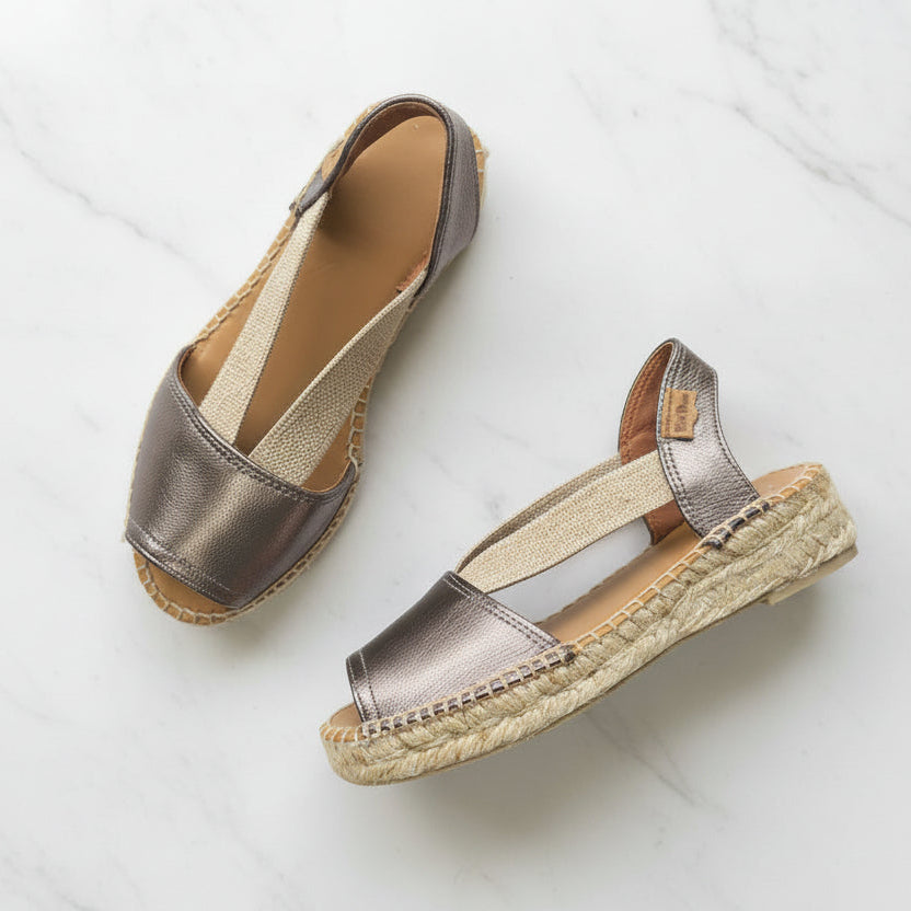 Pair of metallic sandals on a light background