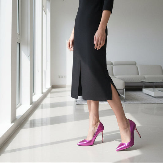 Person wearing a black dress and purple high heels in a modern living room.