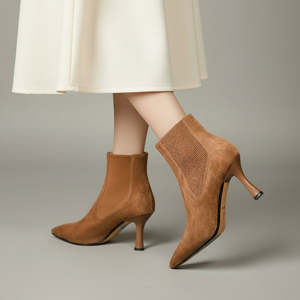 Model wearing ELIANA tan suede petite ankle boots styled with a midi skirt.