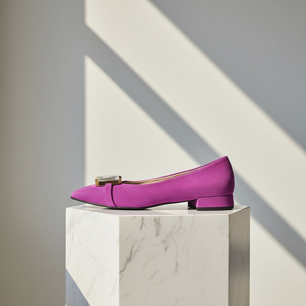 Purple shoe on a marble pedestal with a light gray background