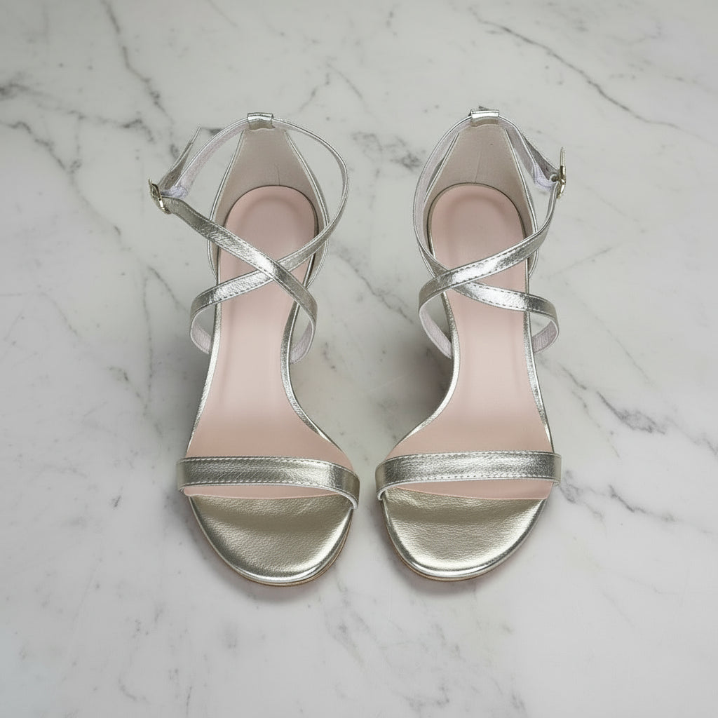 Top view of silver genuine leather FLORENCE heels with delicate straps on marble floor