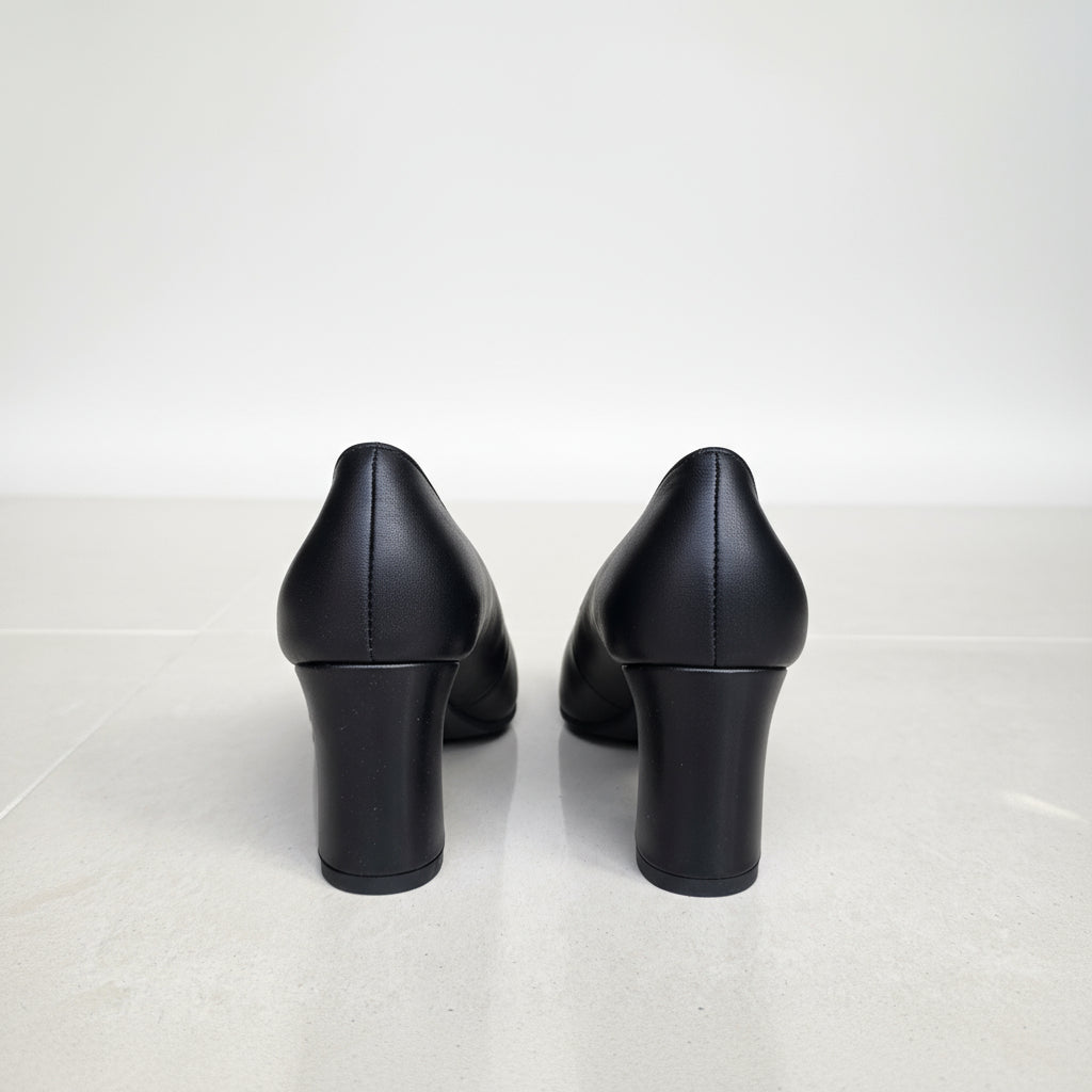 view of GLAM black leather court pumps block heels on polished floor