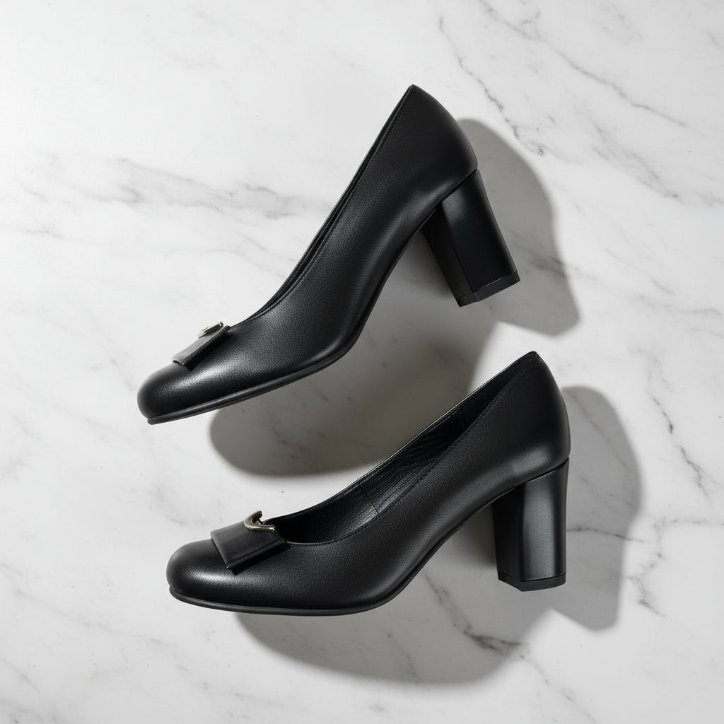 Pair of GLAM black leather block heel pumps showing almond toe and silver detail