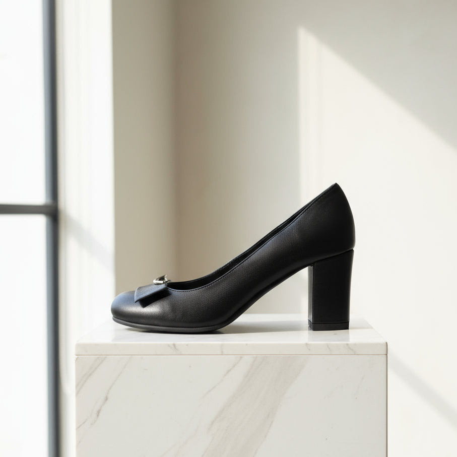 Side view of GLAM black leather almond toe court pump with 7cm block heel