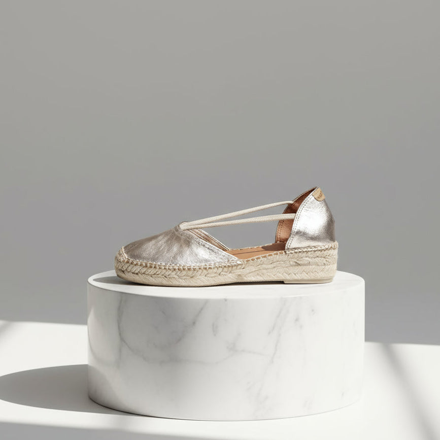 Side profile of gold metallic espadrille with elastic straps and jute sole, made for petite feet.