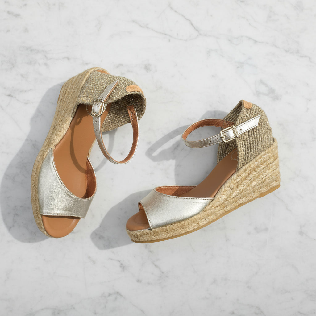 ALISIA gold espadrilles with jute wedge displayed on grass with daisy, perfect summer shoes for small sizes.