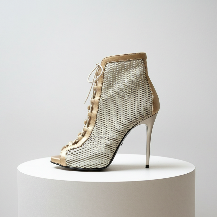 Flatlay of VENUS gold perforated lace-up boots on marble, highlighting perforated leather and platform.