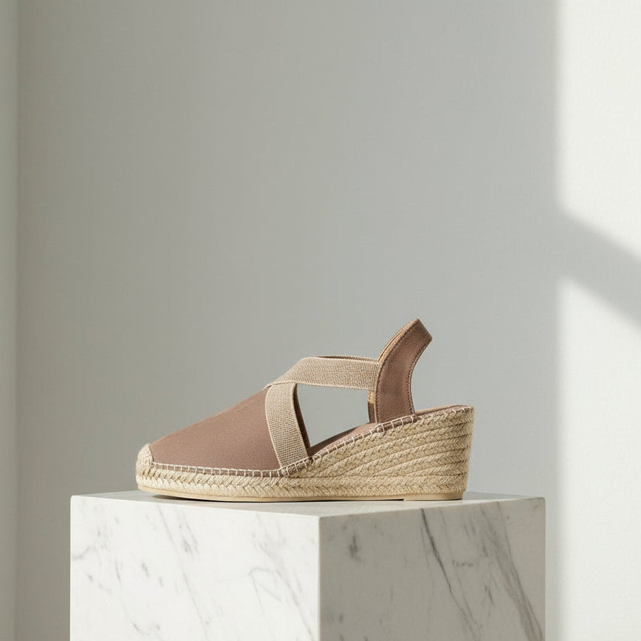 Profile view of taupe HAZEL espadrille showing 6cm wedge heel and elastic crossover band design for petite feet.