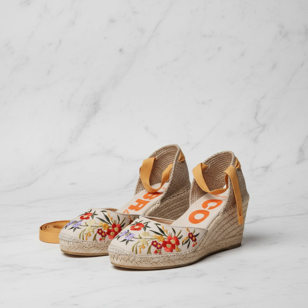Side angle of INES vegan espadrilles showcasing 7cm jute wedge, mustard ribbons and floral embroidery for petite feet.