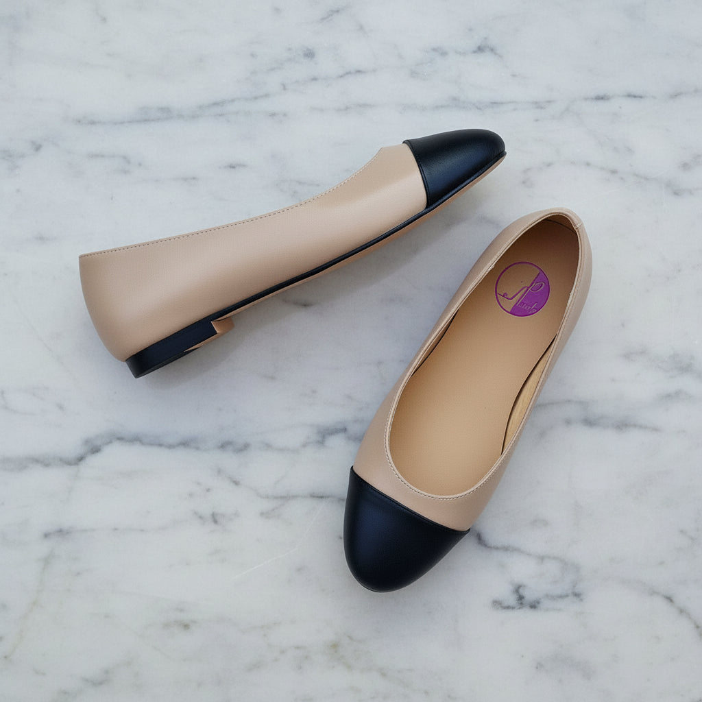 Pair of beige and black leather ballerina flats for petite women, featuring rounded toe and low heel