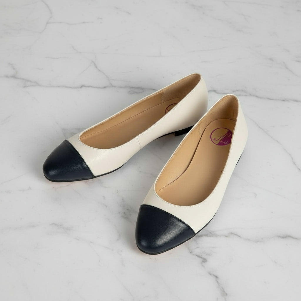  Side view of cream and black leather petite ballerina flats with low heel