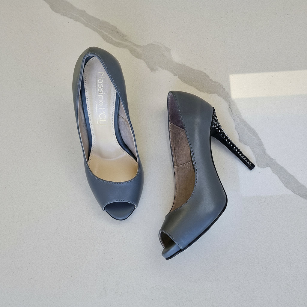 Pair of gray high-heeled shoes on a light gray background