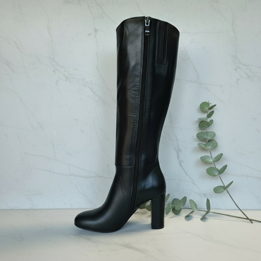 Black knee-high boot on a marble background