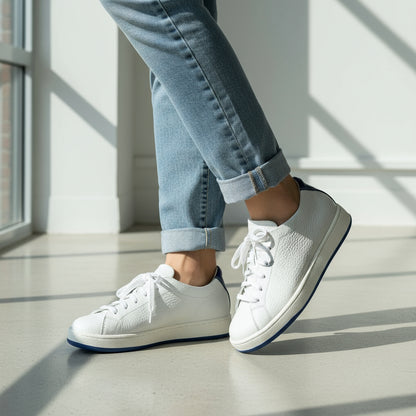 White sneakers with blue accents on a gray background