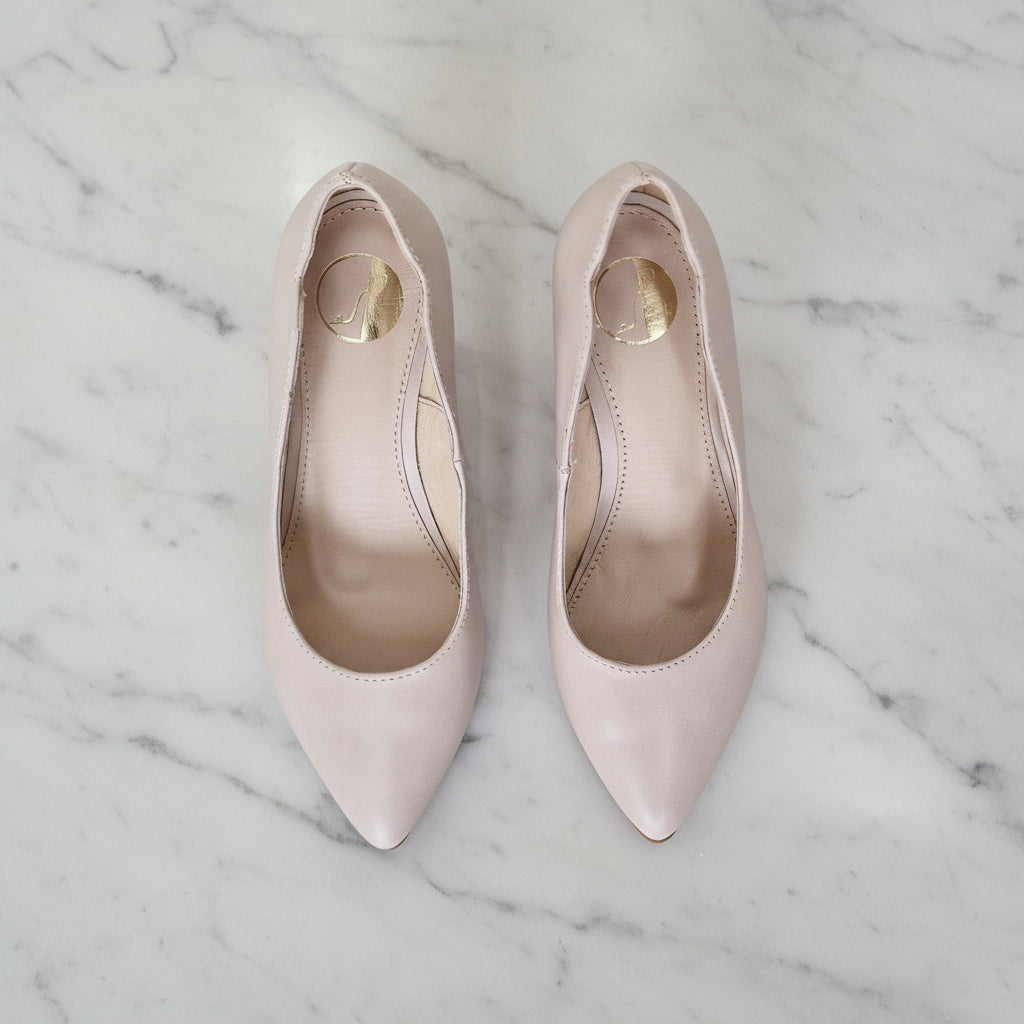 Top view of LUNA nude matte leather kitten heel court shoes on wood surface showing ankle cut-out and leather insole