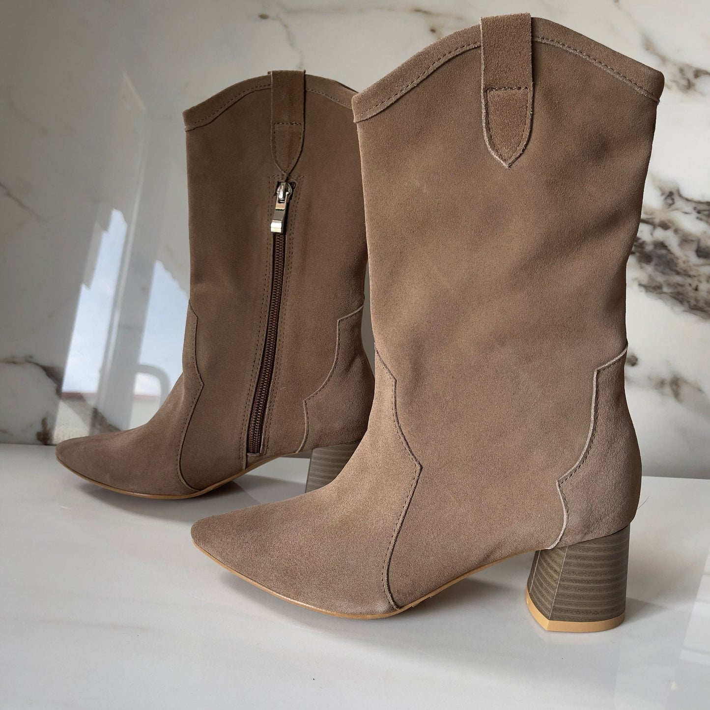 Beige suede ladies western boots set on a cuban heel