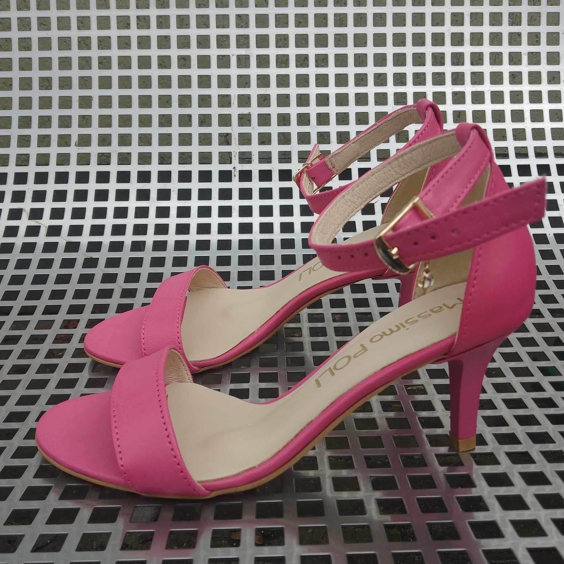 Pink leather kitten heel sandals with an ankle strap and a gold buckle fastening 