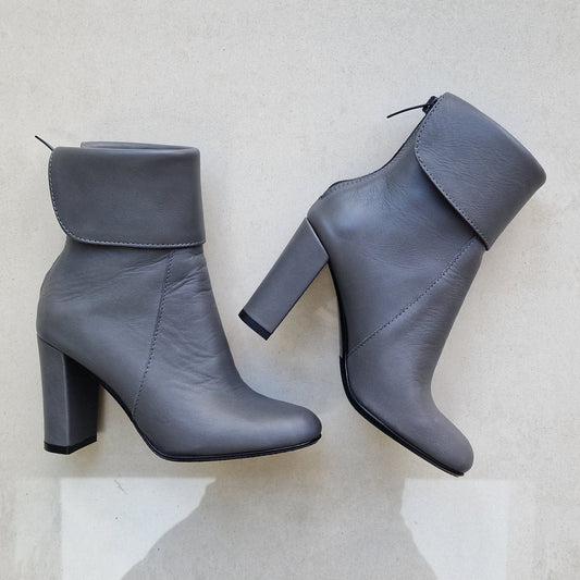Grey leather mid calf boots in small size set on a high heel