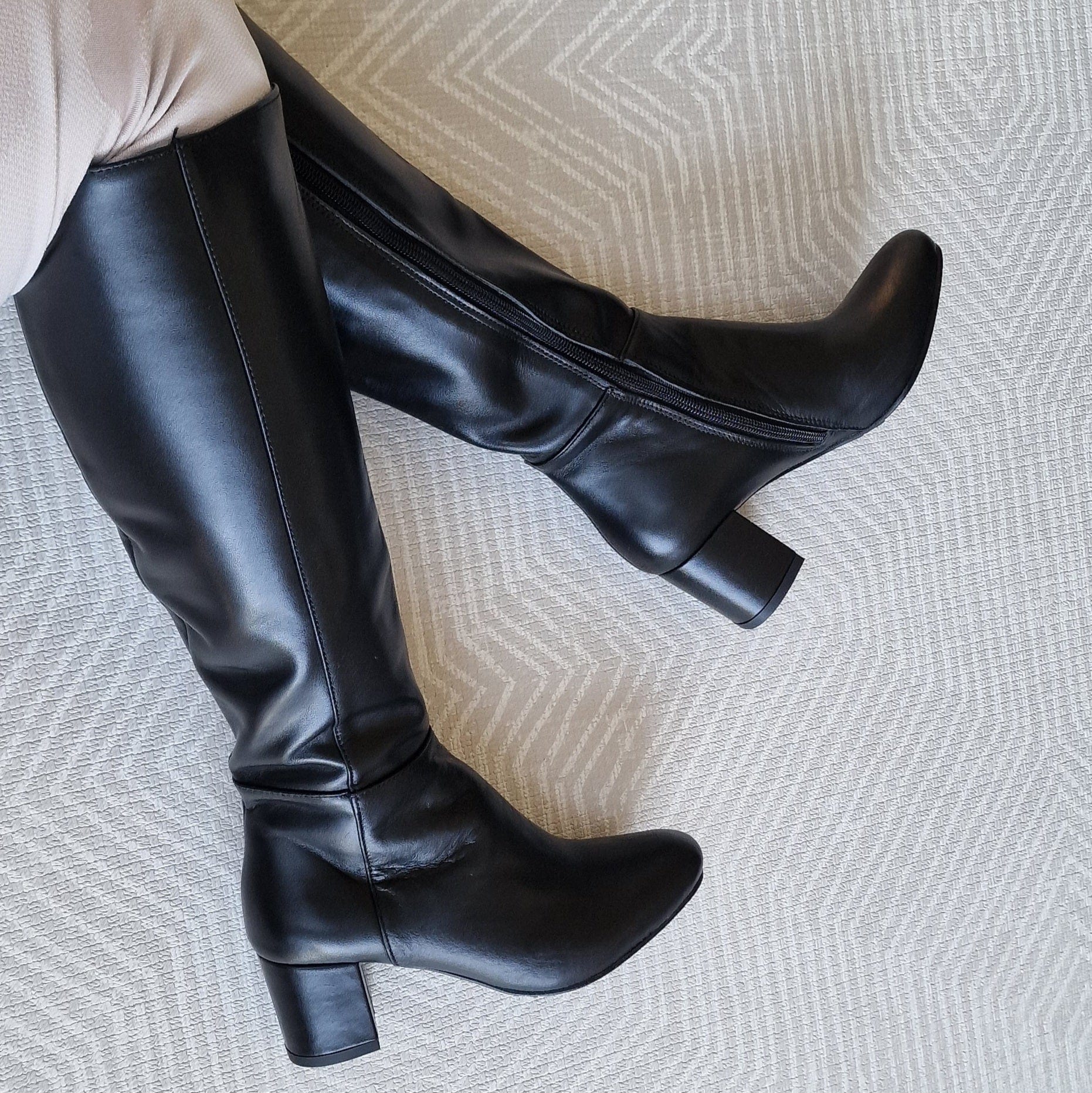 Small size knee high boots set on a mid block heel