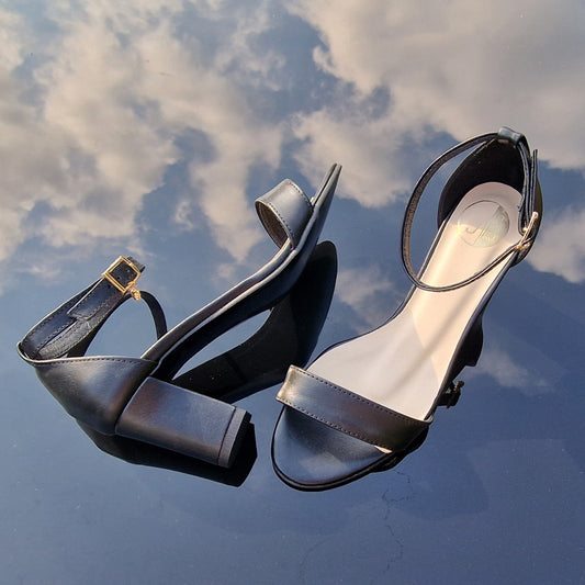Small size ankle strap sandals in black leather set on a block heel
