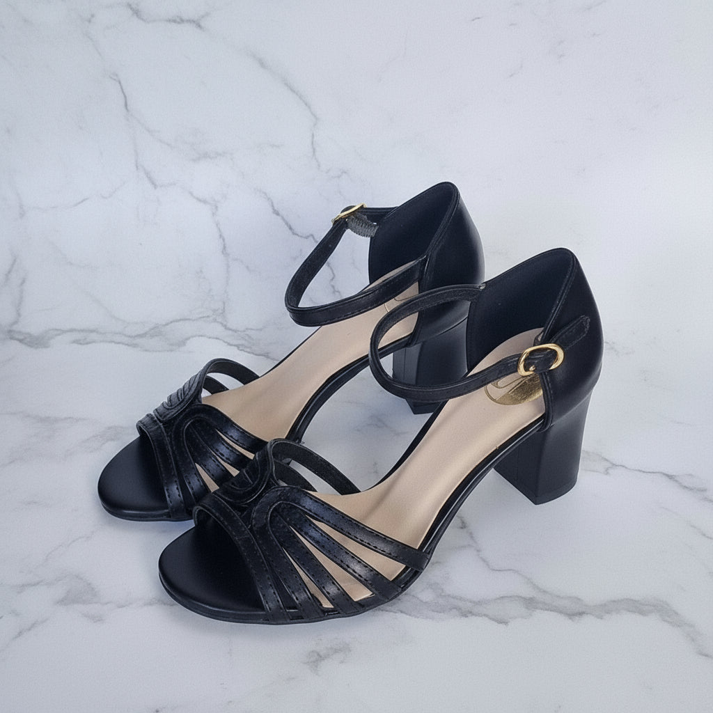 Black high-heeled sandals with open toes on a light gray background