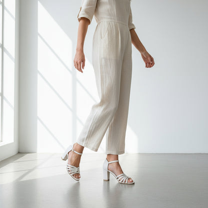 Woman wearing petite ankle strap sandals in nude leather