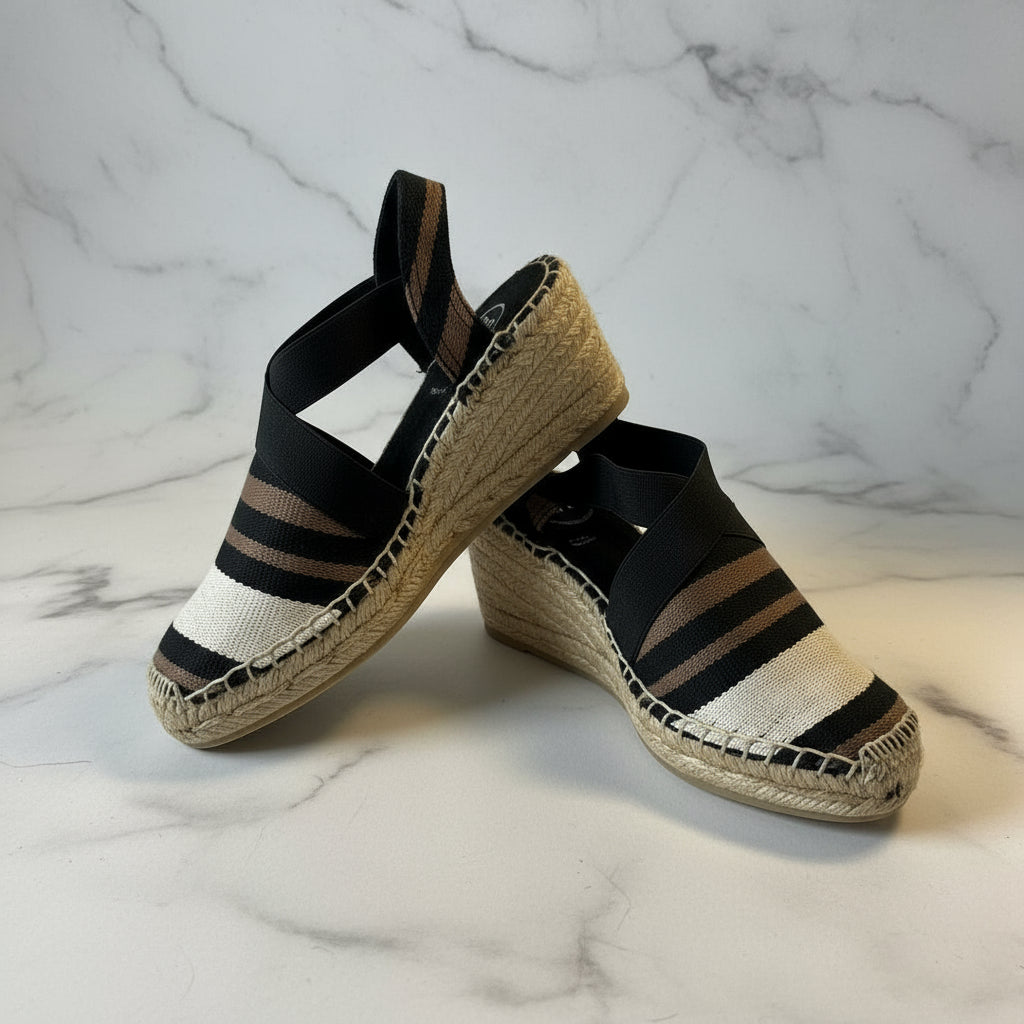 Pair of espadrilles with striped design on a marble background