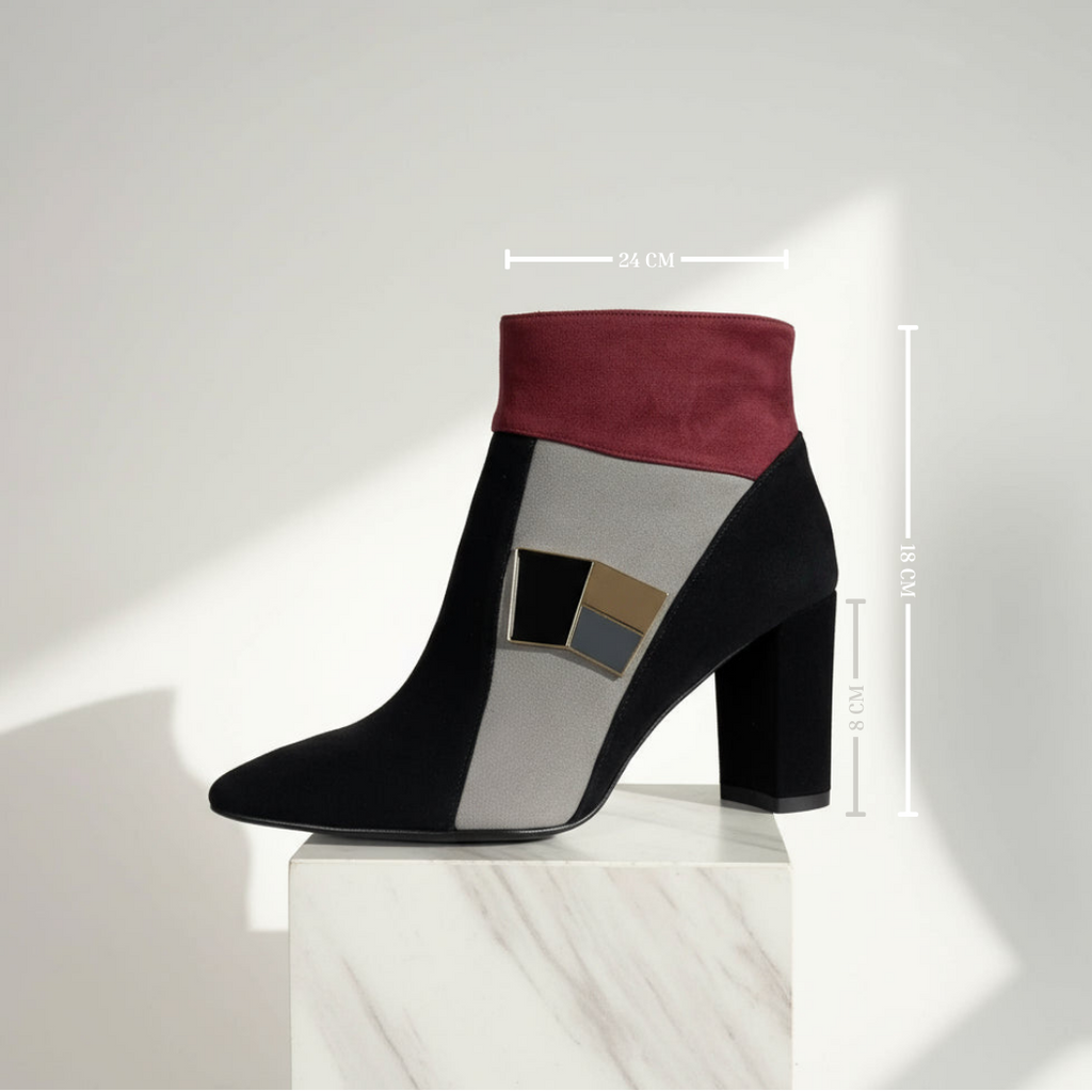Black and red ankle boot on a white pedestal with measurement details.