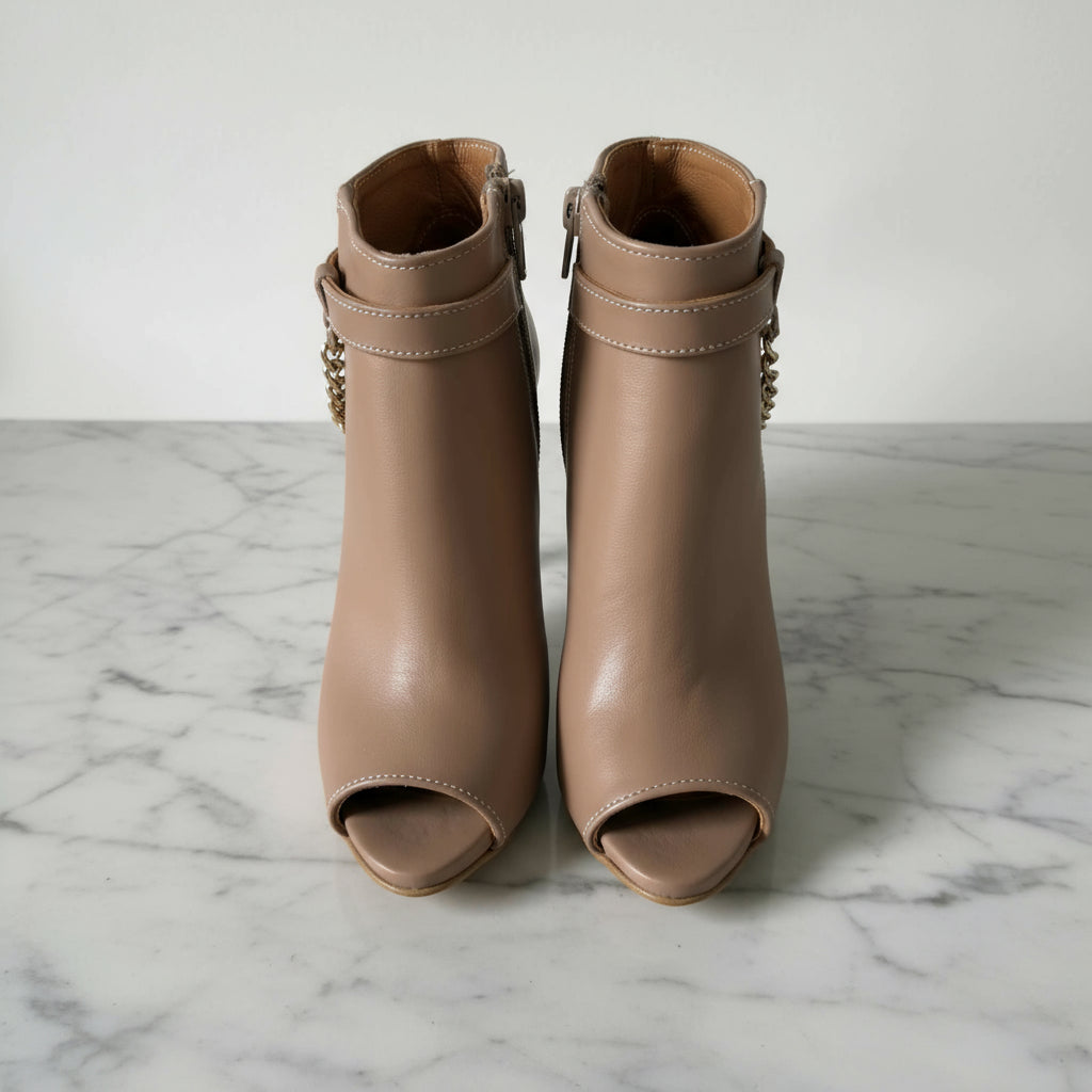 Pair of brown open-toe boots on a white background