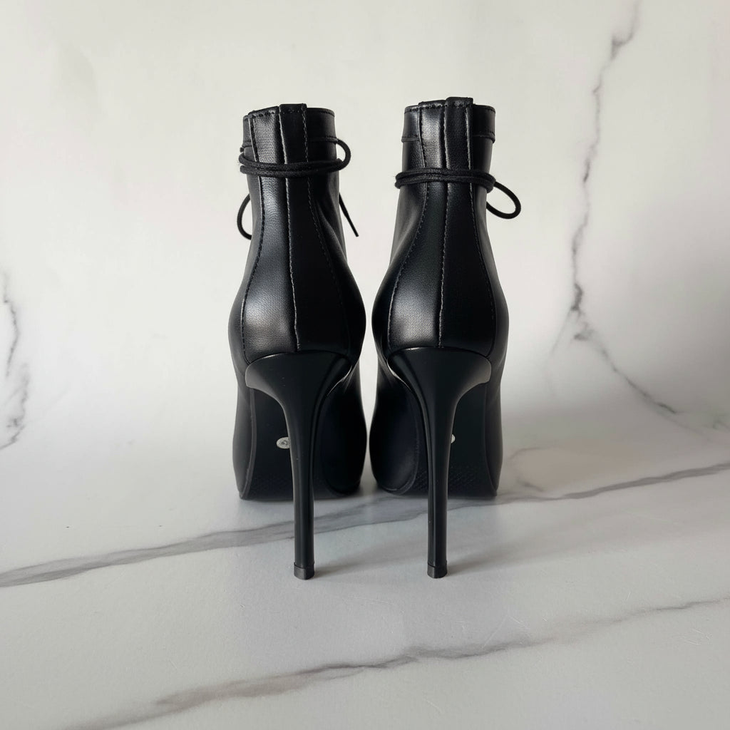 Back view of ORIA ankle boots with slim 10cm stilettos and smooth black leather.