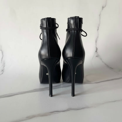 Back view of ORIA ankle boots with slim 10cm stilettos and smooth black leather.